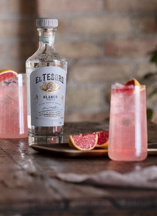 Sparkling Paloma cocktail served in highball glasses with a grapefruit wedge garnish.